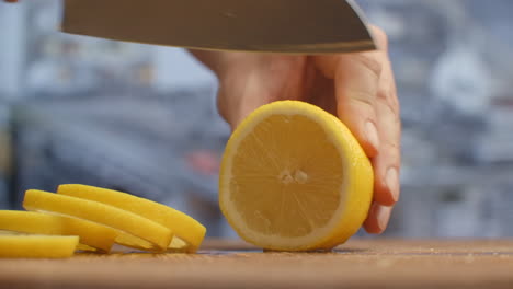 Cut-with-a-knife-on-a-wooden-board-close-up-of-a-lemon-in-the-kitchen.-shred